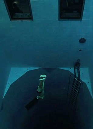 The astonishing video sees the 29-year-old plunging, without any breathing equipment whatsoever, a staggering 33metres to the bottom of the NEMO 33