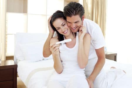 мужчина и женщина рассматривают тест на беременность